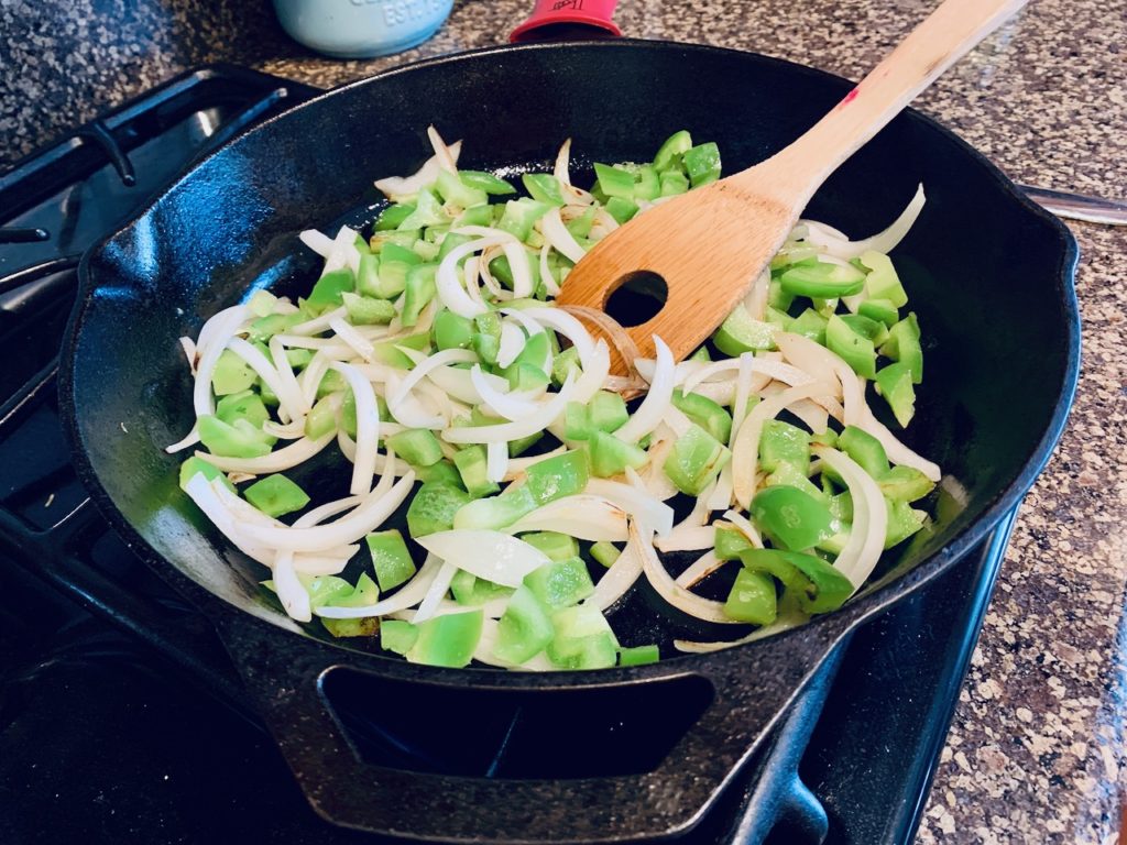 cooking bell peppers and onions