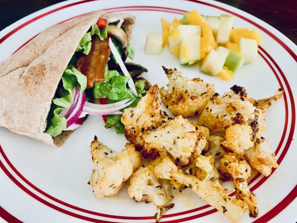 Pita Sandwich with a side of cauliflower. 