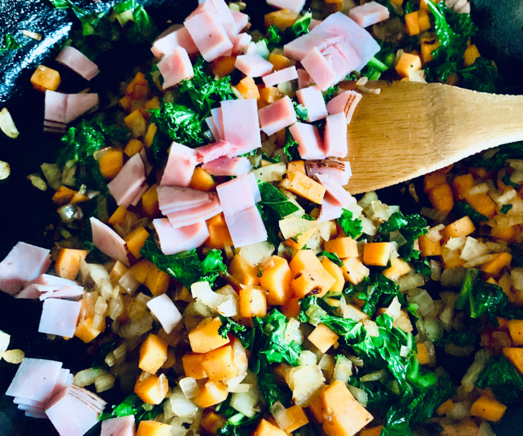 Sweet Potato, ham and Kale in a cast iron skillet