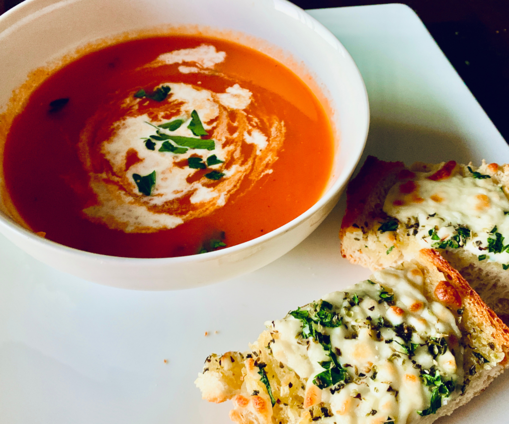 Bowl of Tomato Basil Soup with Garlic Cheesy Bread