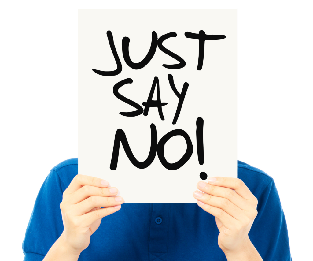 person holding sign that says "just say no!"